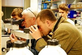 People at light microscope